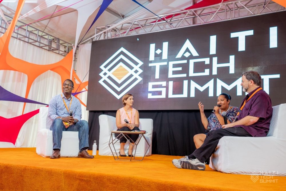 Michael Dennin (right) and fellow panelists speaking at the 2018 Haiti Tech Summit.