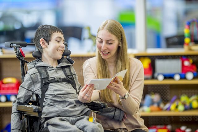 Woman reads to child in wheelchair