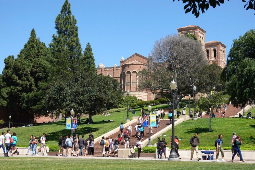 Students on the UCLA campus, with the Janss Steps and Royce Hall in the background.