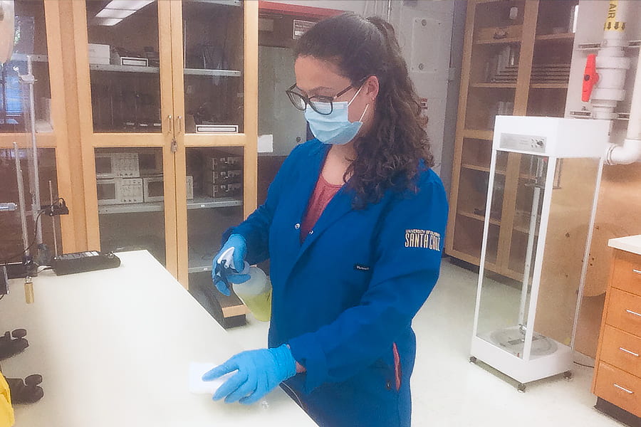 Laboratory manager Sophia Sholtz sanitizes each lab bench, according to safety protocol, before setting up a new experiment (photo by Sophia Sholtz)