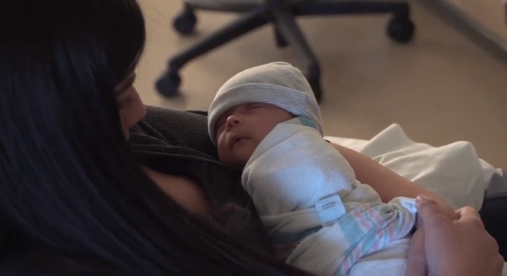 A mother holding her newborn baby