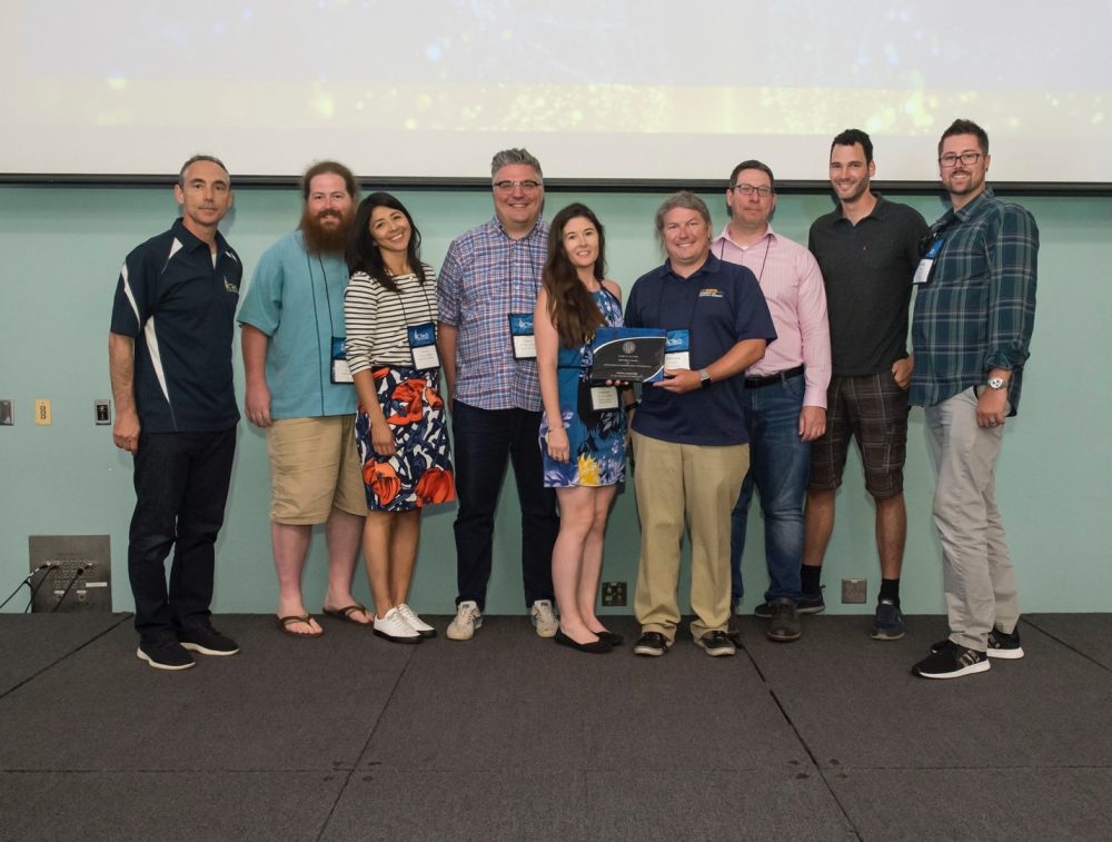 UC Tech 2019 Sautter Awards presentation. Mayra Solano, 3rd from left; Kristen Lineberger, 5th from left; and Shawn DeArmond (UCD), center, holding plaque.