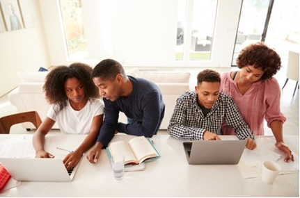 Parents and their kids working on laptops