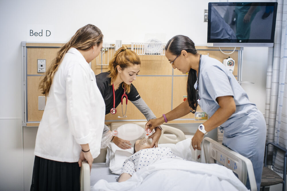 Hospital workers help a patient