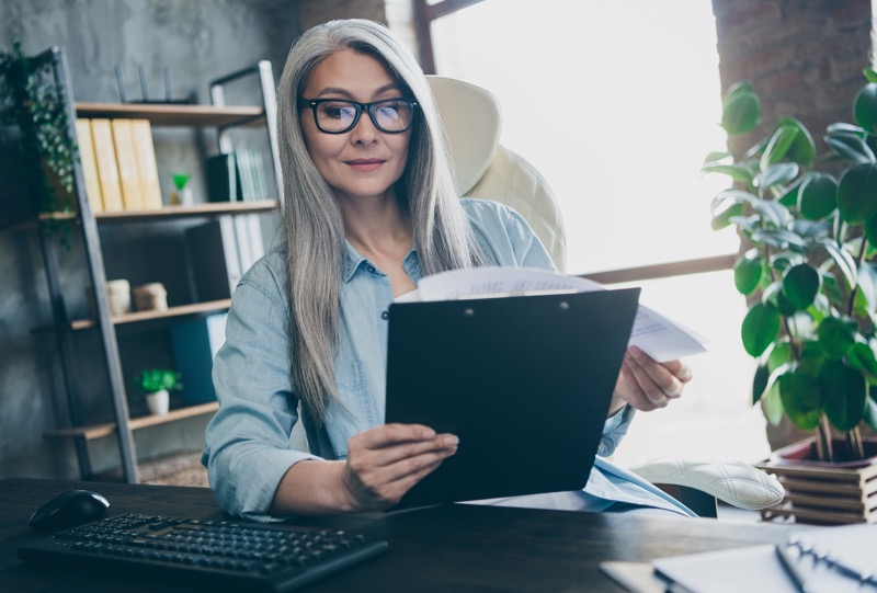 Woman with computer reading a list