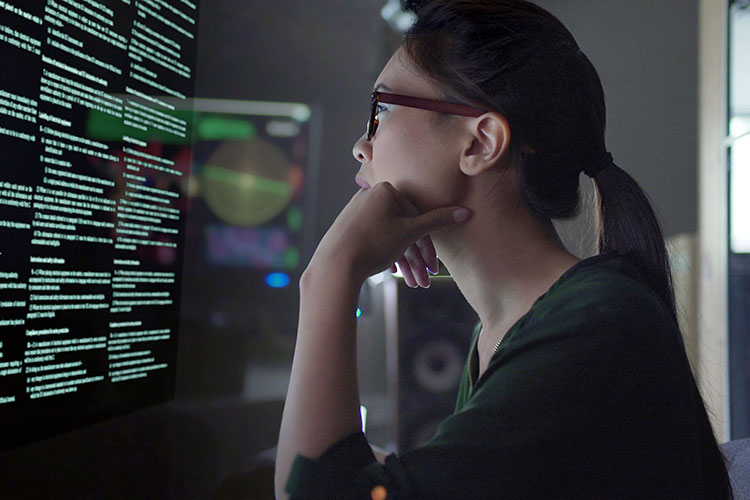 Woman looks at computer screen