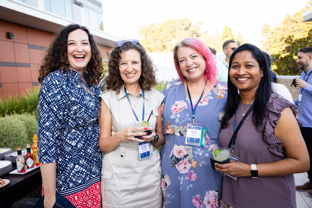 4 people smiling at the UC Tech conference