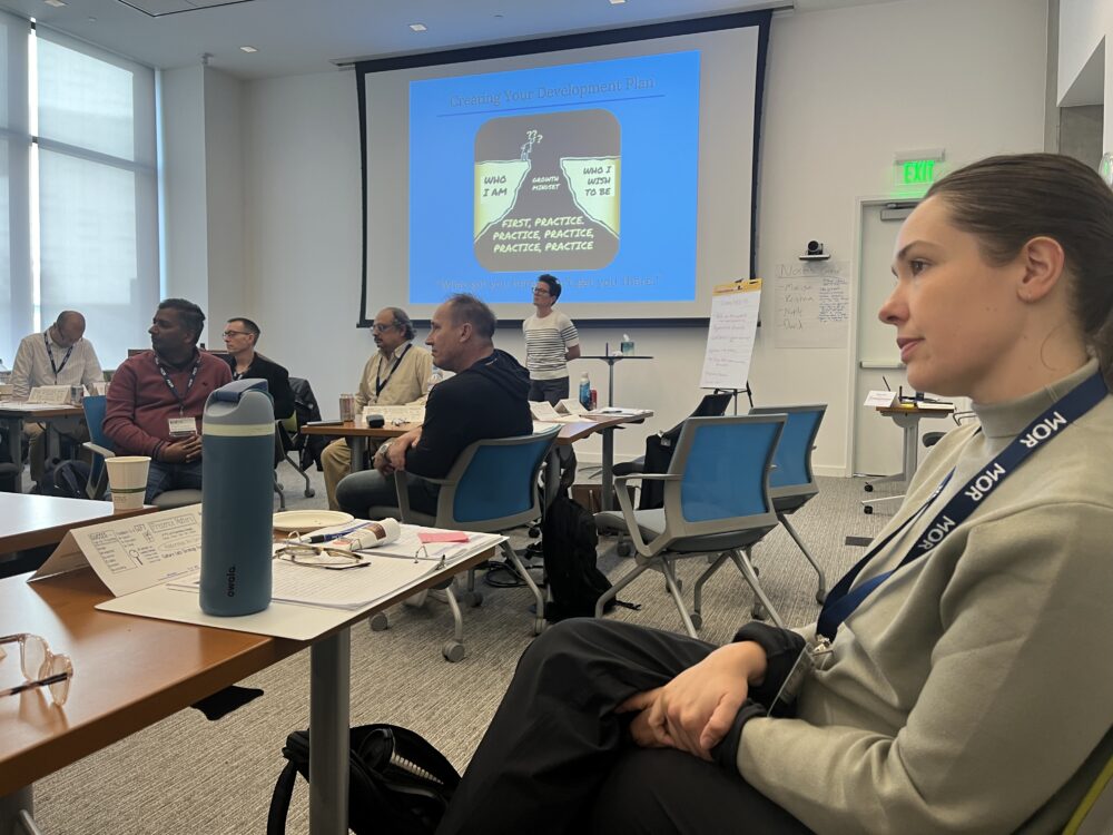 Conference room with woman wearing MOR lanyard