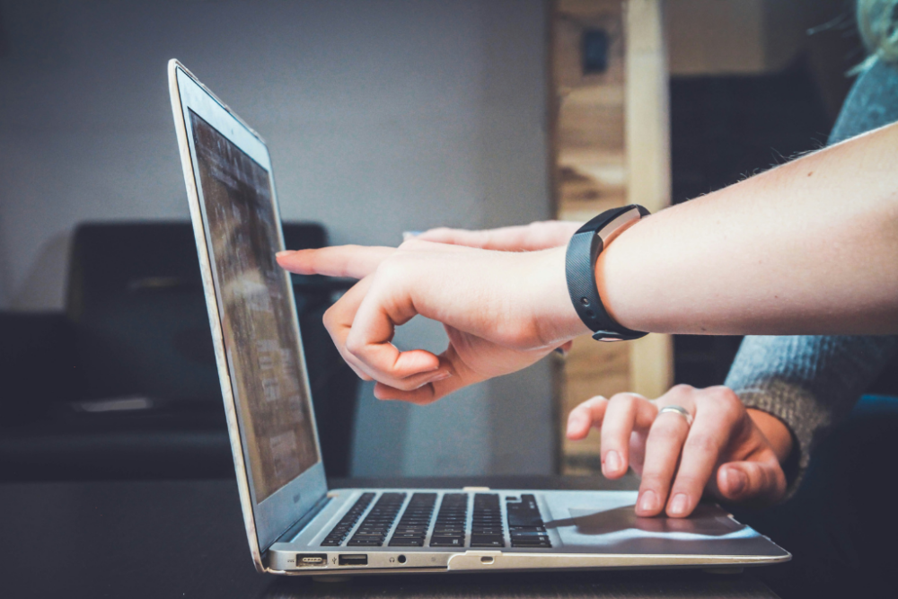 Person pointing at computer