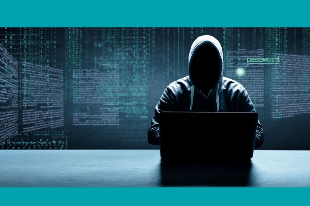 Hooded hacker at a computer