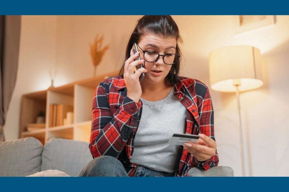 Woman on phone holding credit card