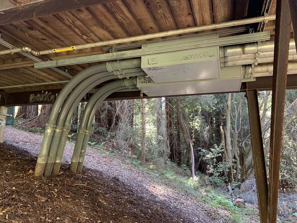 Conduits running under a bridge on campus. 